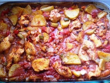 Oven baked chicken casserole with vegetables cooked in tomato sauce 