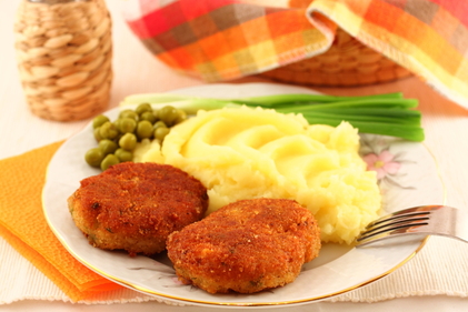Homemade oven baked pork cutlets with mash and peas