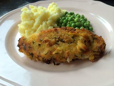 Homemade oven baked pork cutlets with mash and peas