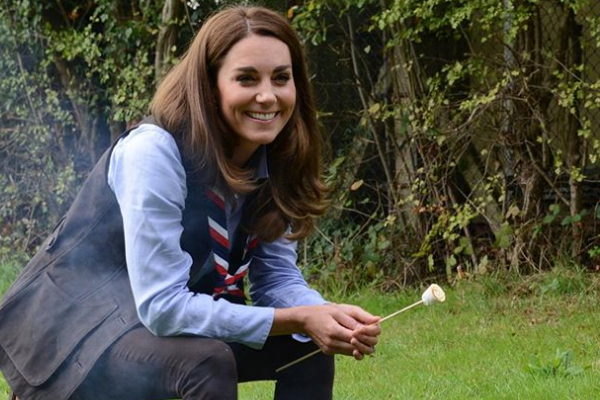 Kate wears her camping clothes to toast marshmallows over cosy bonfire